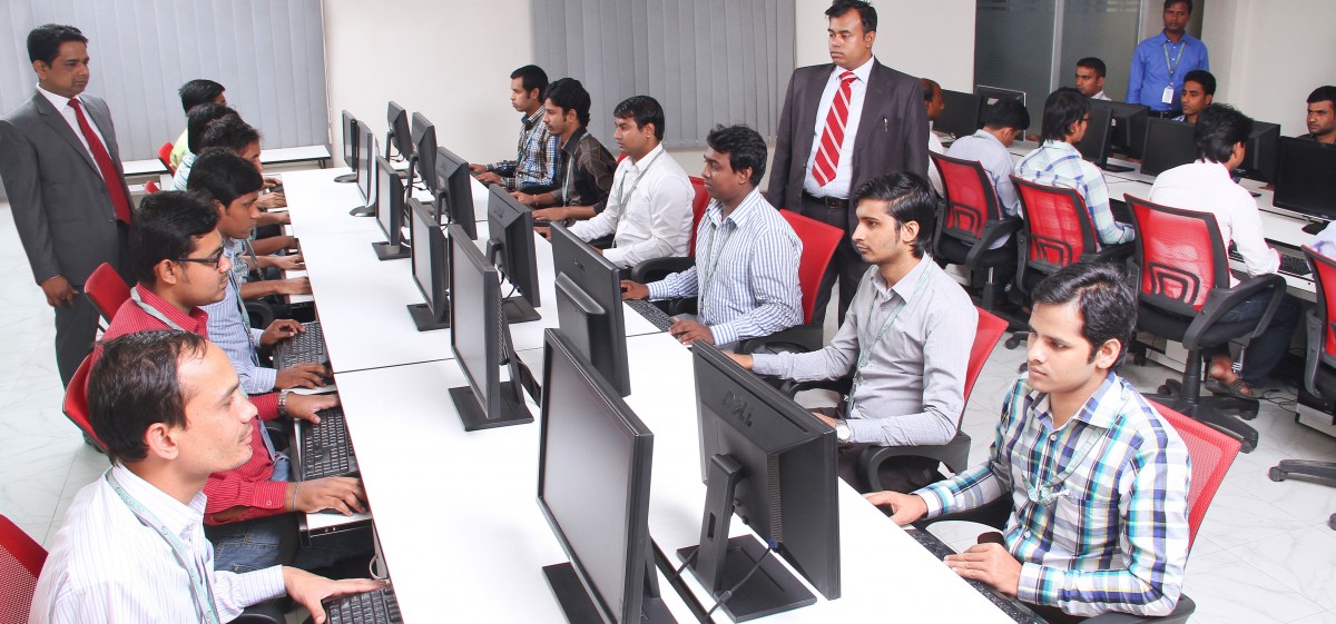 Team of Indian developers and managers working in an open office concept