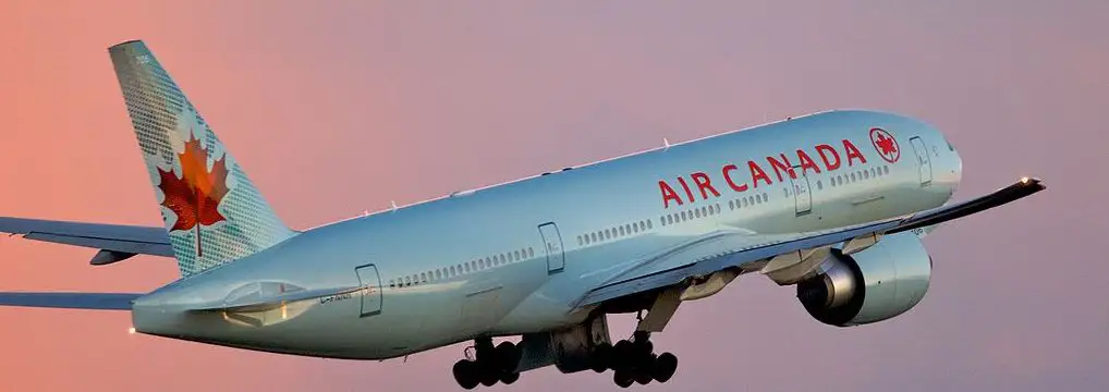 air canada flight flying in purple and pink background