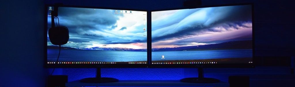 Dual monitor entertainment computer with neon blue background