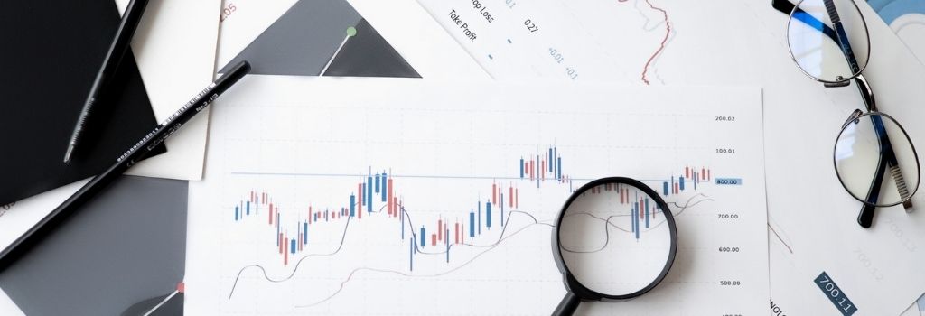 magnifying glass over charts